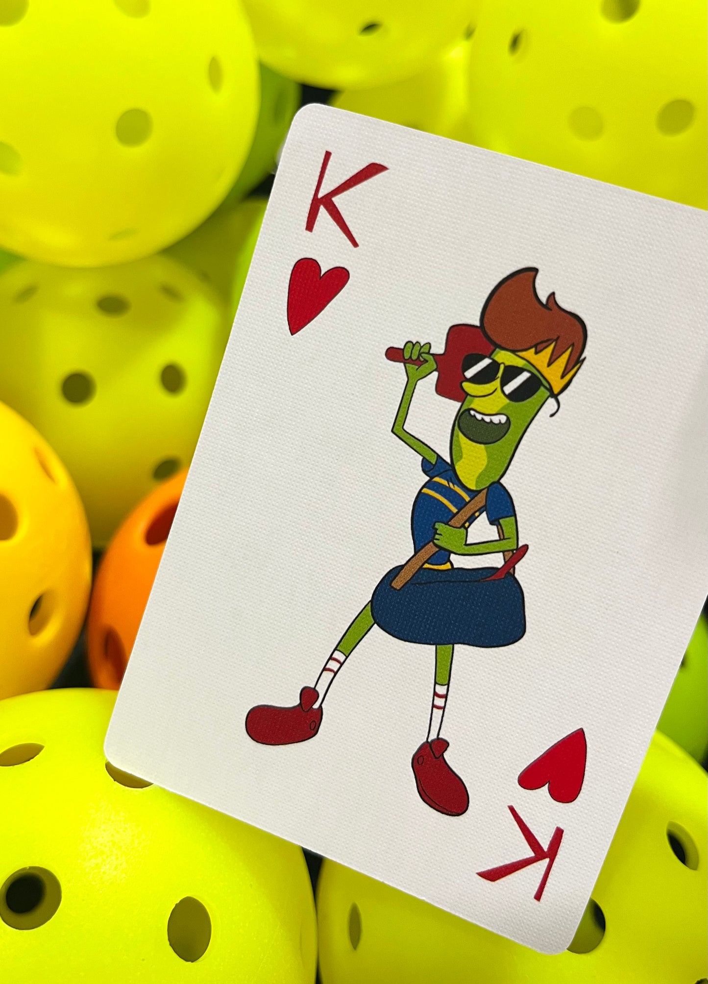 king of hearts pickleball playing card with king holding paddle behind his head and carry a bag