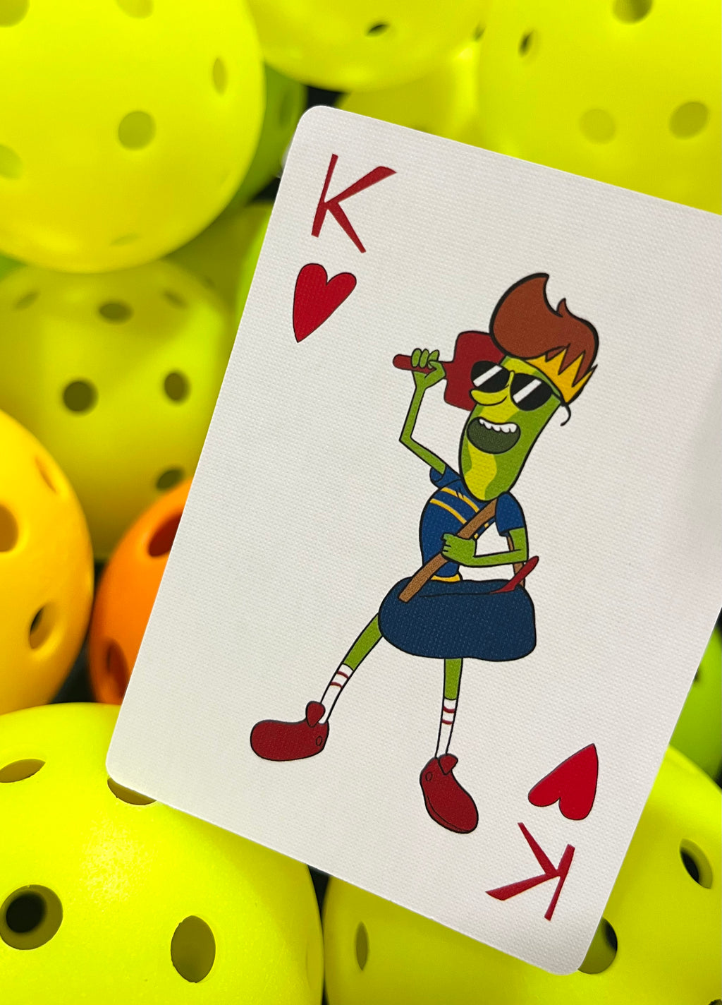 king of hearts pickleball playing card with king holding paddle behind his head and carry a bag